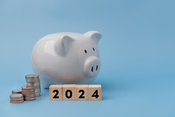 Wooden Cube Calculator and coin on White Piggy Bank . Business savings money and budgeting...