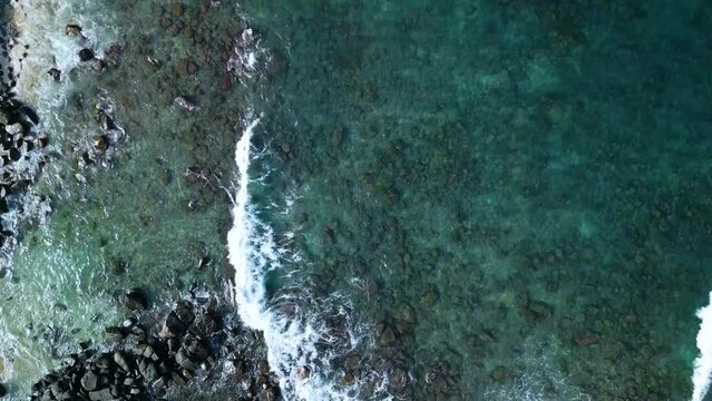 Aerial video of Dondra Lighthouse surrounded by tropical trees and the sea, Sri Lanka