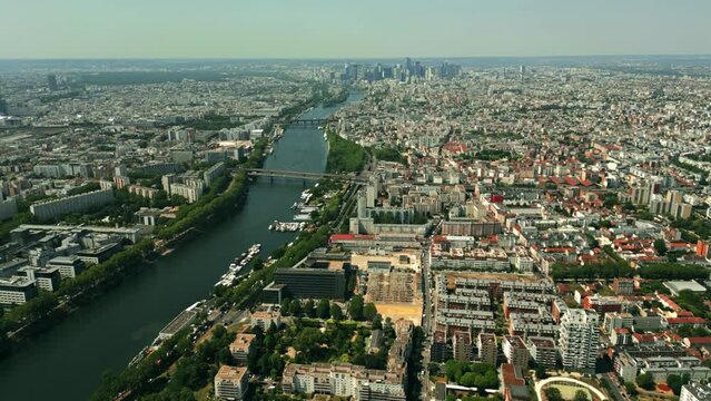 Aerial view of northern neighborhoods of Paris and distant La Defense business district on the Seine River, France