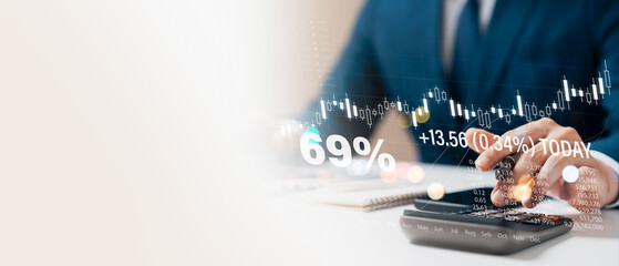 Businessman using calculator to calculate financial figures and analyze growth Stock Market and Digital Markets and Business Strategy, Banking and Finance, Business Investing in the Global Economy.