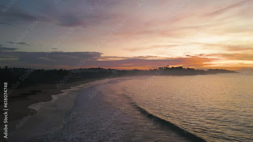 Canvas Prints Aerial of the golden sunset shining behind the calm waters of the sea in Sri Lanka