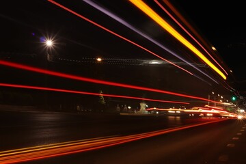 Fototapeta na wymiar Long exposure shot of the light trails of transportation along the road in the city at night