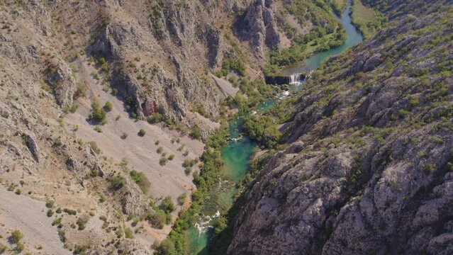 Wide shot of kayaks cruising in Zrmanja river turquoise blue water, aerial