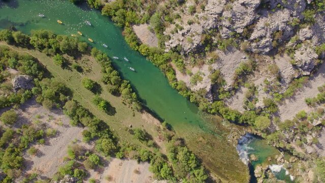 Kayaks paddling towards small waterfall at zrmanja river Croatia, aerial