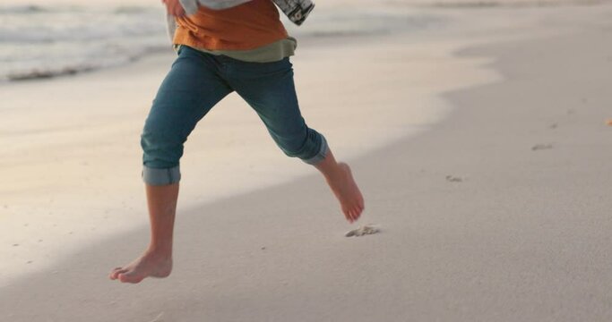 Travel, vacation and closeup of a child running on the beach for adventure, freedom or fun. Barefoot, speed and zoom of a boy kid walking on the sand by the ocean or sea while on a tropical holiday.