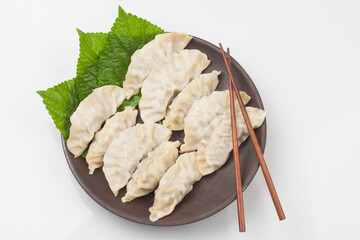 
A food made by kneading flour and adding stuffing to it. It is cooked by boiling, steaming, or...