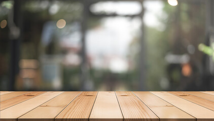 Empty wooden table top with lights bokeh on blur restaurant background.