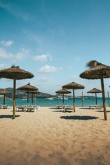 Picturesque beach scene with a variety of beach chairs and umbrellas scattered on the sand