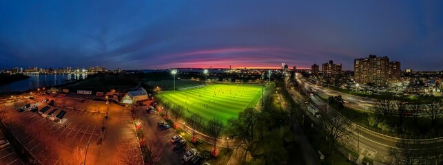 Aerial view of Calvert Vaux Park in Brooklyn, New York during a beautiful and colorful sunset - obrazy, fototapety, plakaty