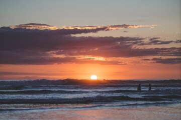 People are captured enjoying their activity during a beautiful sunset