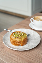 Still life of round Croissants with Pistachio grain and coffee