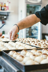 unrecognizable man cooking buns. Traditional Italian cuisine