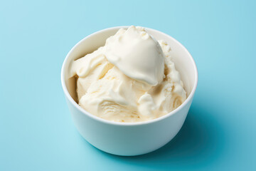 Above view of delicious vanilla milk ice cream in a round white vase isolated on a light pastel blue background. Copy space for text. Generative AI photo.
