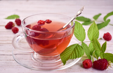 Aromatic tea from raspberries in a cup.Close-up.
