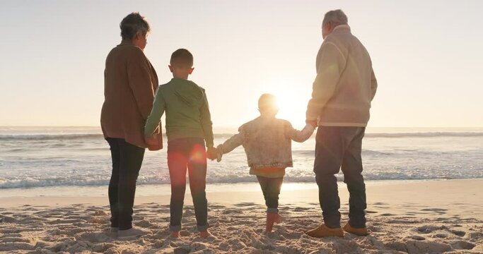 Family holding hands, grandparents and grandkids on the beach, sunrise and nature with back view and ocean. Love, care and support, vacation and solidarity, old woman and man with children outdoor