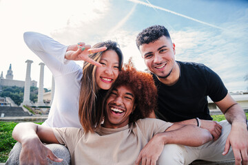 Group of young multiracial friends hugging and having fun together. Three happy cool buddies...