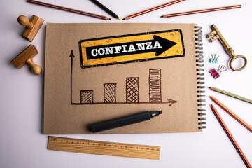 Trust Concept. Text in Spanish. Office supplies on the table
