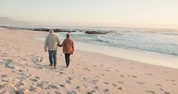 Love, beach and senior couple walking by ocean for commitment, bonding and quality time at sunset. Marriage, travel and man and woman relax for romance on holiday, vacation and anniversary together