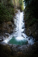 Majestic waterfall cascading down a rocky mountainside in British Columbia, Canada