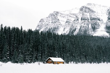 Picturesque cabin with a snow-covered backdrop in the stunning scenery of Lake Louise in Canada