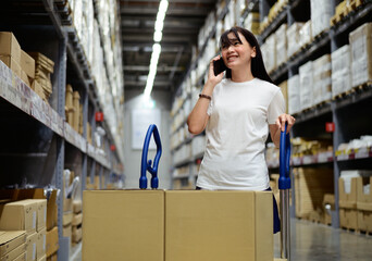 Portrait of asian customer talking on smartphone in warehouse factory