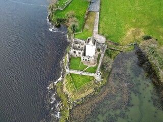 Aerial view of the Doe Castle separated with waters and lush vegetation in Donegal, Ireland
