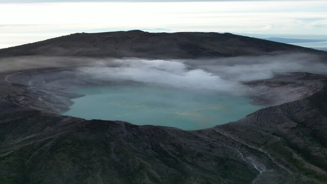 Aerial landscape scene of Kelimutu colorful volcano lakes in Indonesia with cloudy sky