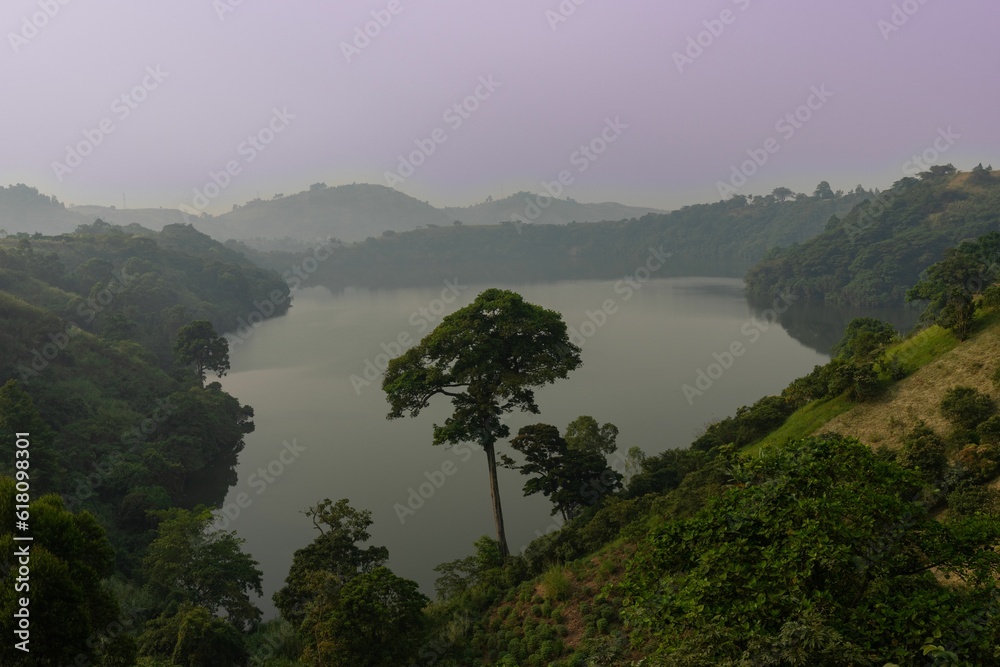 Sticker breathtaking landscape featuring lush green vegetation covering the distant mountain range