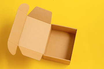 Opened cardboard box Isolated on yellow  background.