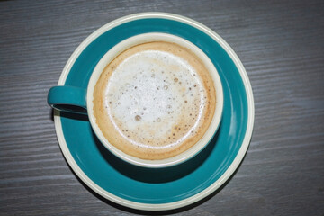 A mug of coffee in a cafe. A hot drink in a mug. Coffee in a coffee shop