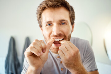 Teeth, dental floss and portrait of man in bathroom for self care, oral hygiene and morning routine. Cleaning, smile and health with face of male person at home for beauty, wellness and results
