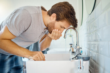 Man in bathroom, mouth wash and water with morning routine, health and wellness in home. Dental...