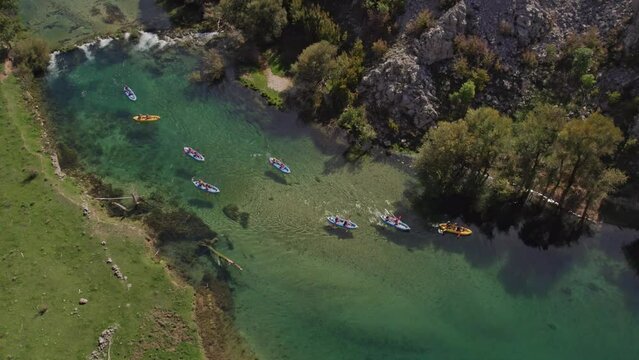 Kayaks on clear blue water at zrmanja river Croatia during summer, aerial, top down
