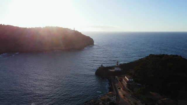 Drone view over boats near Soller Port in the sea with green mountains at sunset in Mallorca