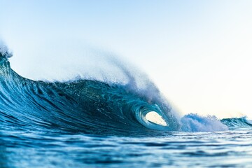 Large, powerful wave crashing against the shoreline of a beach © Brent Makana Potter/Wirestock Creators