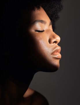 Face shadow, light and black woman with beauty, natural skincare glow and calm with facial cosmetics routine. Wellness profile, dermatology and African studio person with self care on grey background