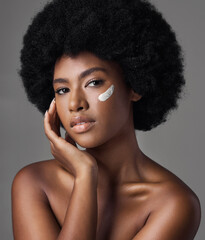 Black woman in portrait, cream and beauty with skincare and cosmetics product on studio background....