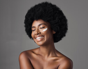 Fototapeta na wymiar African woman, beauty cream and studio with afro, skincare and cosmetics by grey background. Girl, happy model and healthy with natural glow on skin with makeup, clean aesthetic and product for face