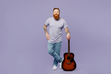 Full body young happy fun cool redhead bearded man he wear violet t-shirt casual clothes play...