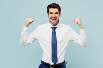 Fototapeta premium Young employee business man corporate lawyer wear classic formal shirt tie work in office doing winner gesture celebrate clenching fists say yes isolated on plain pastel light blue background studio.