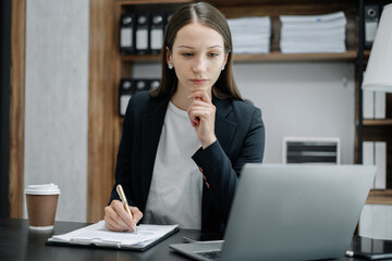 business woman working at office with laptop and documents on his desk, financial adviser analyzing data.