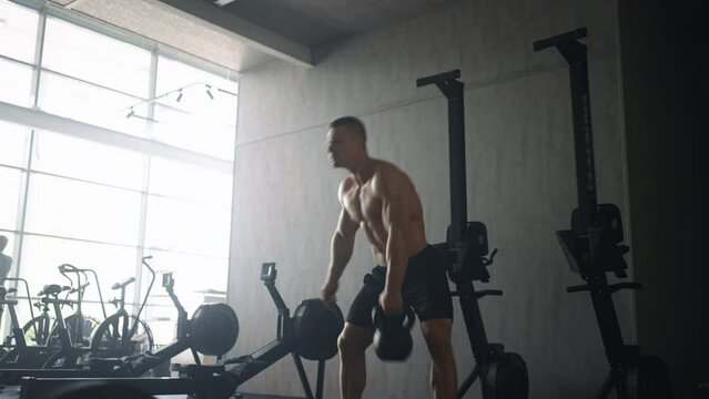 Jock Training In Gym, Lifting Kettlebells And Training His Body, Nude Torso With Relief Muscles