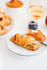 Apple cinnamon pastry rolls on white wooden table