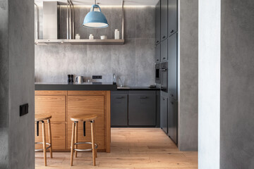 kitchen island with dark countertop at stylish apartment