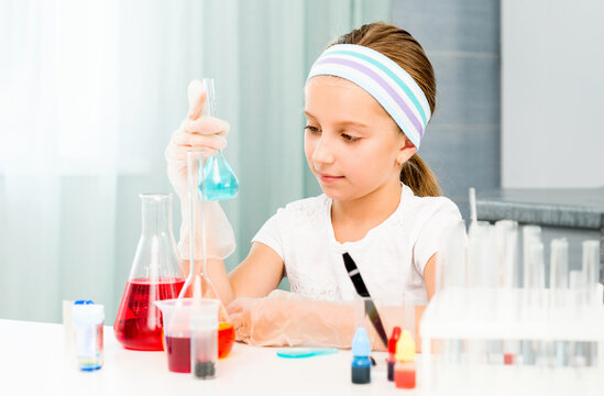 cute little girl with flasks for chemistry