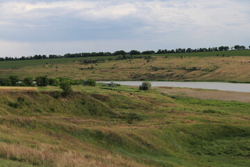 Fototapeta na wymiar A grassy field with a river