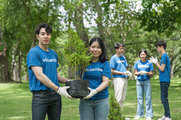 Portrait, flowers and young volunteering in park for community, outreach or program together....