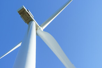 detail of  wind turbine blases and pivit high in the sky