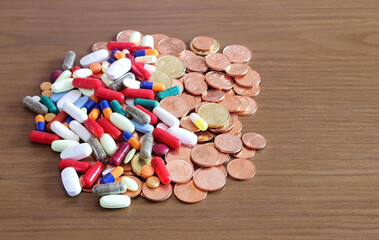 Fototapeta na wymiar Medicines and coins. Concept of health care expenditure.