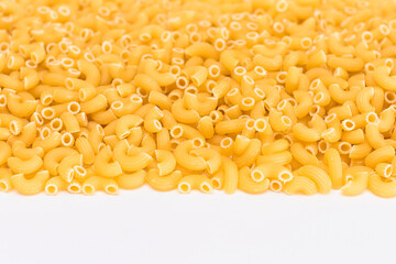 Uncooked Chifferi Rigati Pasta Scattered on White Table. Fat and Unhealthy Food. Classic Dry Macaroni. Italian Culture and Cuisine. Raw Pasta